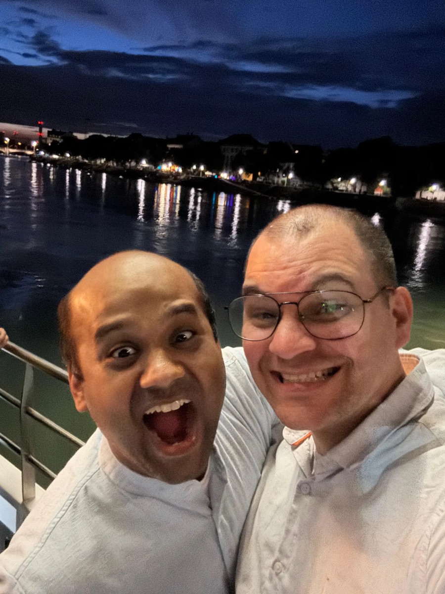 Krishi and Suraj on a boat at night